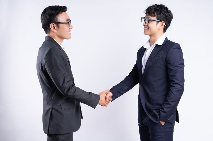 two asian business men shaking hands on a white background premium photo